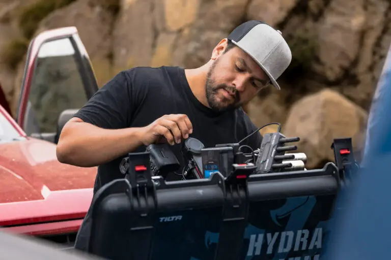 Creative director preparing cameras for a commercial content creation day